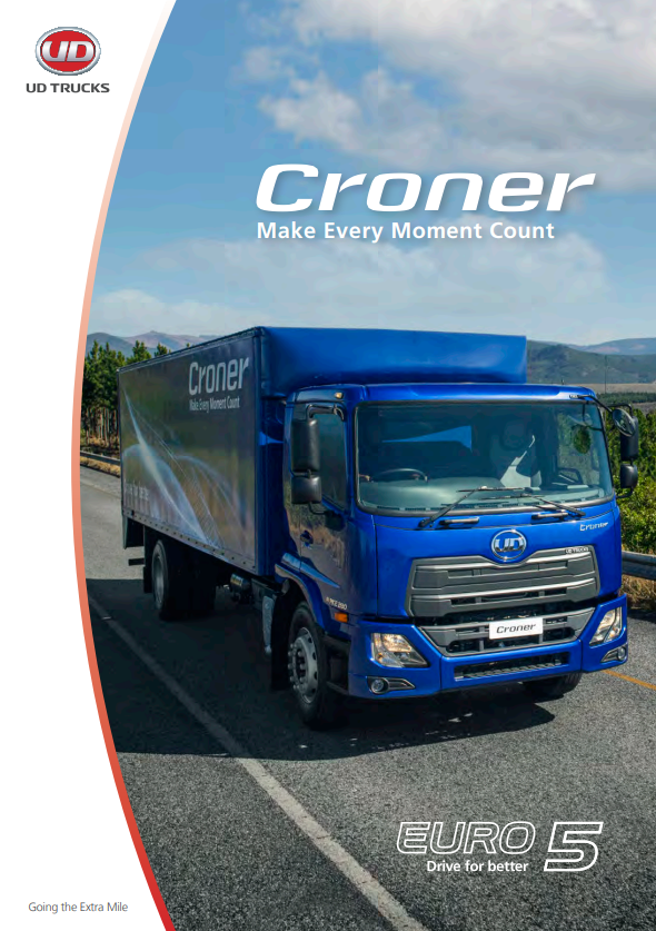 Camión azul Croner circulando en carretera bajo cielo parcialmente nublado.