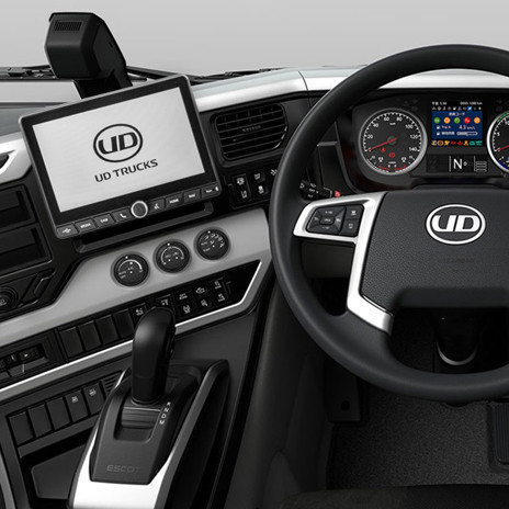 UD Trucks dashboard with digital displays, steering wheel, and gear lever.
