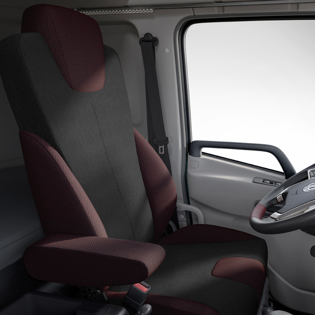 Asiento de auto gris con textura y apoyabrazos lateral.