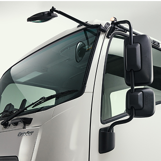 Close-up of a white truck cab with large side mirrors and a clear windshield