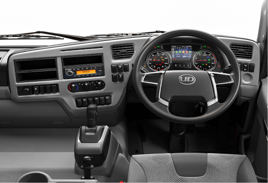 Dashboard ng isang modernong trak, may manibela at makukulay na gauge.